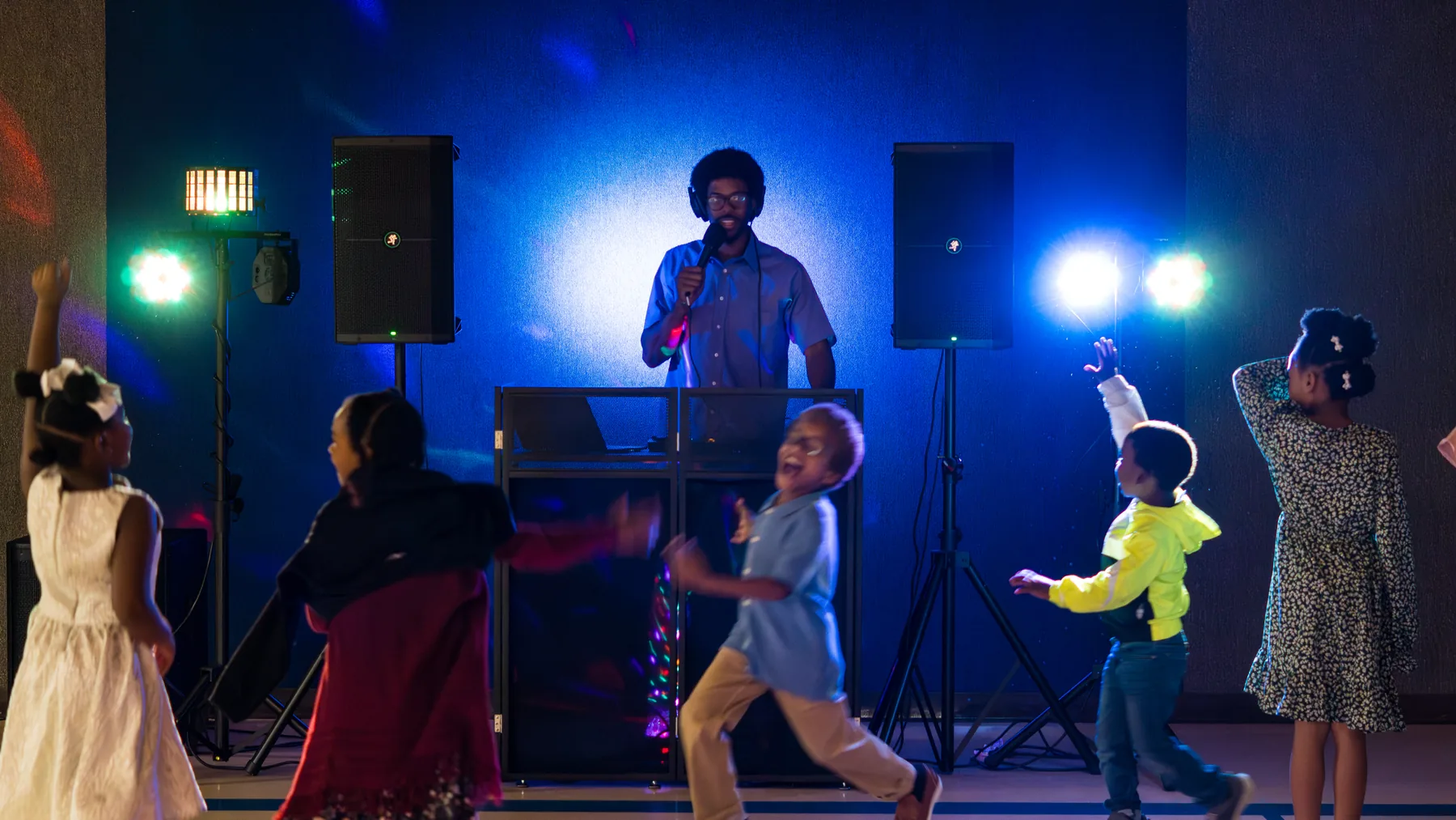Children dancing in front of Ian Wade's DJ setup