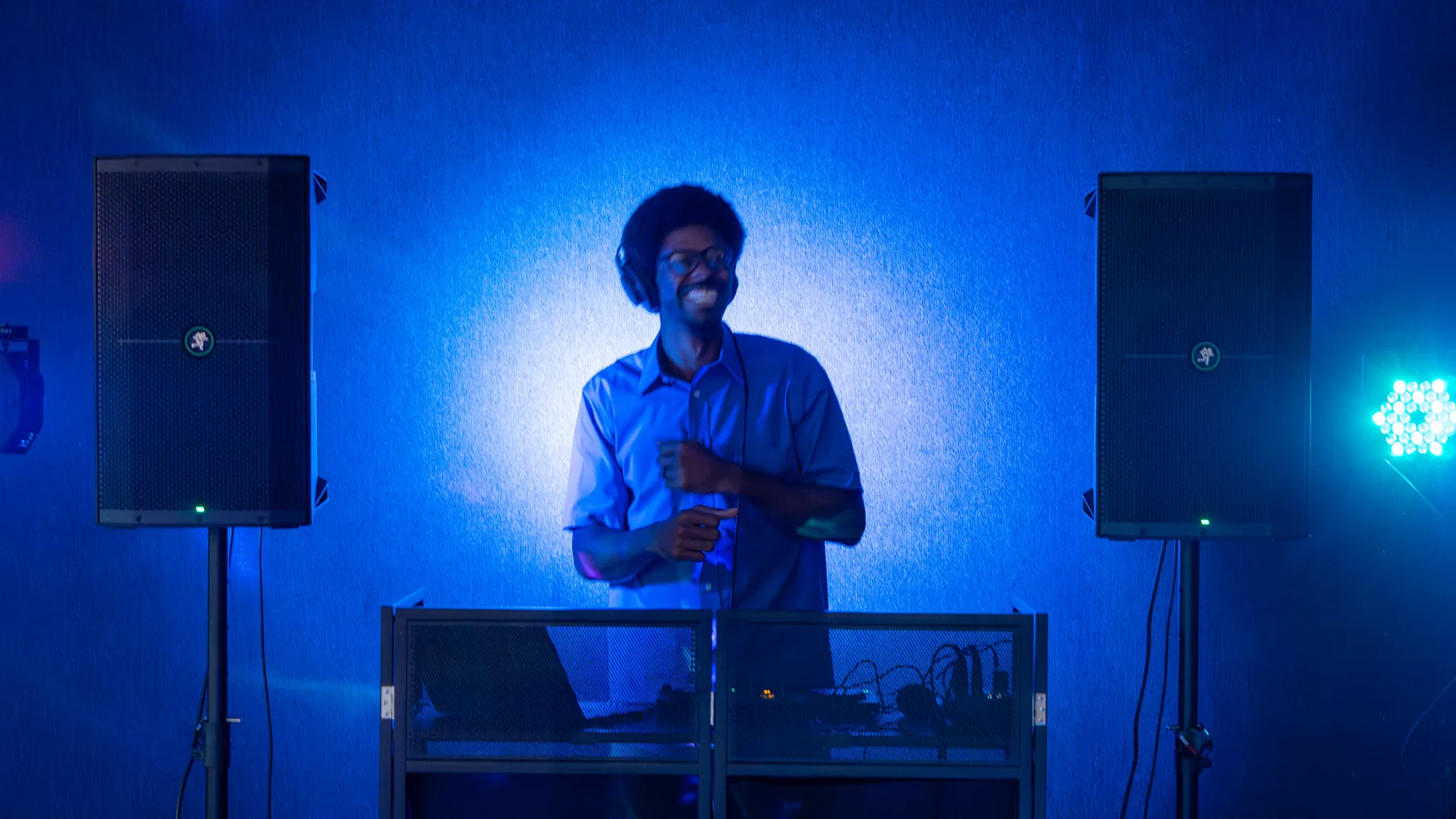 Ian Wade smiling behind his professional DJ setup