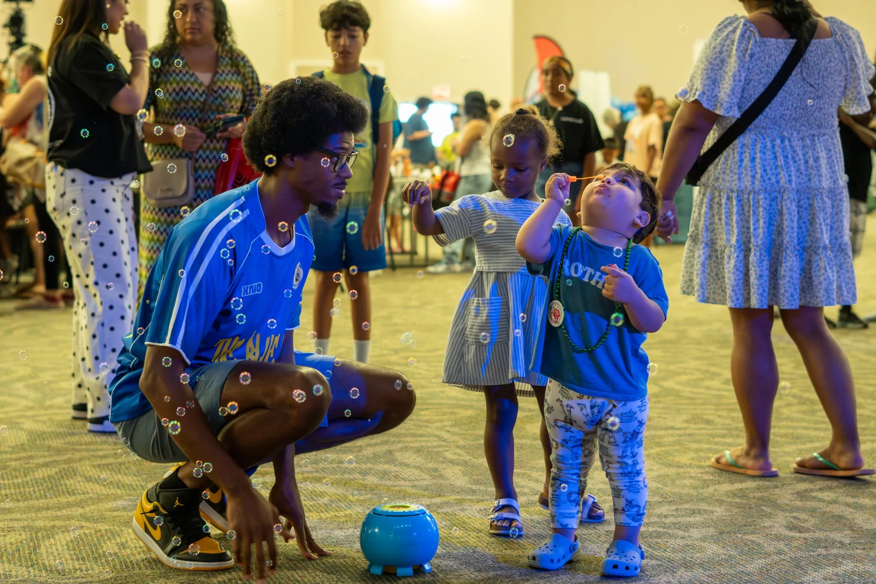 Ian Wade engaging children with bubbles at a family event