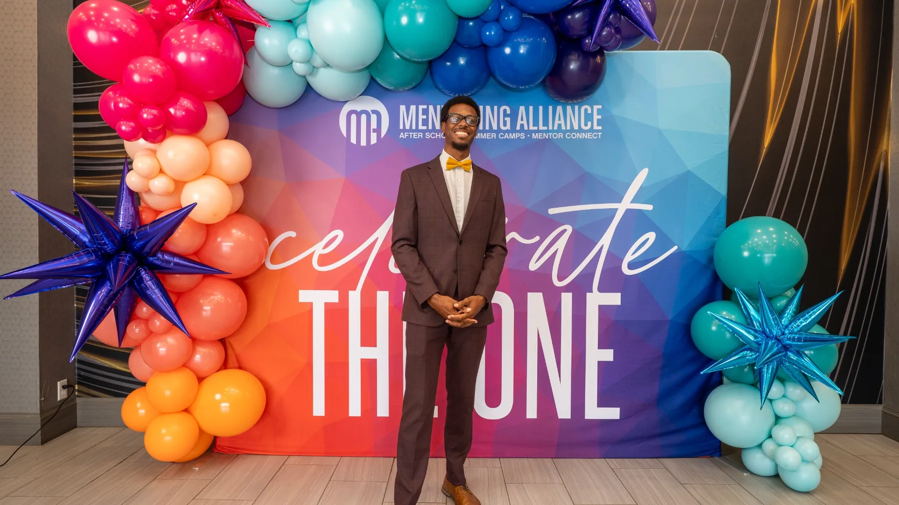 Ian Wade standing at the Mentoring Alliance Celebrate the One event